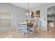 Dining room area with a round table, pendant lighting, and a large picturesque painting at 14556 Unbridled Dr, Orlando, FL 32826