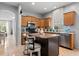 Kitchen featuring an island with bar seating, stainless steel appliances, and tile flooring at 14556 Unbridled Dr, Orlando, FL 32826