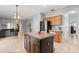 Open kitchen with granite island, stainless steel appliances and a seamless view into the living room at 14556 Unbridled Dr, Orlando, FL 32826