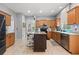 Kitchen area with a dark island, tile flooring and wooden cabinets at 14556 Unbridled Dr, Orlando, FL 32826