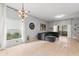 Bright living room featuring tile floors, neutral paint, and sliding glass doors to the outdoor patio at 14556 Unbridled Dr, Orlando, FL 32826
