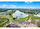 Aerial view showcasing a Primary-planned community with a central lake, private beach, boat dock, and scenic walking trails at 14722 Porter Rd, Winter Garden, FL 34787