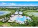 A luxurious community pool features a splash area, ample seating, and meticulous landscaping, perfect for relaxation at 14722 Porter Rd, Winter Garden, FL 34787