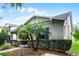 Charming home with lush landscaping featuring palm trees and a manicured hedge at 14722 Porter Rd, Winter Garden, FL 34787