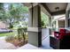 Inviting front porch with seating and stately columns, perfect for relaxing and enjoying the neighborhood views at 14722 Porter Rd, Winter Garden, FL 34787
