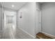 Spacious hallway showcasing tile flooring and neutral walls, providing a clean and inviting transition between rooms at 14722 Porter Rd, Winter Garden, FL 34787