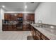 Spacious kitchen featuring granite countertops, stainless steel appliances, and plenty of dark wood cabinets at 14722 Porter Rd, Winter Garden, FL 34787