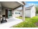 Covered patio with sliding glass doors and view of the green backyard at 14722 Porter Rd, Winter Garden, FL 34787