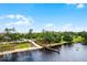 Scenic aerial view of a wooden walking bridge leading to a tranquil lake, surrounded by lush greenery and mature trees at 14722 Porter Rd, Winter Garden, FL 34787