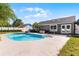Large backyard features a refreshing pool, fire pit, lush greenery, and a white fence at 150 Dempsey Way, Orlando, FL 32835