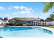 Inviting pool area surrounded by lush landscaping, a fire pit, and a charming gazebo at 150 Dempsey Way, Orlando, FL 32835