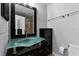 Modern bathroom featuring a unique glass vessel sink, cabinet, and dark finishes at 150 Dempsey Way, Orlando, FL 32835