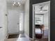 Foyer with a white front door, tile flooring, and a glimpse into the bedroom with hardwood floors at 150 Dempsey Way, Orlando, FL 32835