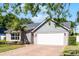 Charming single-story home featuring a gray exterior, well-maintained landscaping, and a brick-paved driveway leading to a two-car garage at 150 Dempsey Way, Orlando, FL 32835