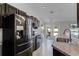 Well-equipped kitchen featuring stainless steel appliances, dark cabinetry, granite countertops, and access to an outdoor patio at 150 Dempsey Way, Orlando, FL 32835