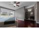 Main bedroom with hardwood floors, large window, and a modern vanity, creating a cozy and inviting retreat at 150 Dempsey Way, Orlando, FL 32835