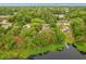 Aerial view of the property featuring lake access and surrounded by lush trees at 151 Naranja Rd, Debary, FL 32713