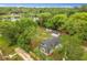 Aerial view of the property showcasing the home, large yard, lake, and surrounding trees at 151 Naranja Rd, Debary, FL 32713