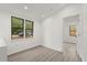 Bright bedroom with hardwood floors, large windows, and a closet with a doorway at 151 Naranja Rd, Debary, FL 32713