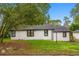 Exterior view of the home with grass and a black roof at 151 Naranja Rd, Debary, FL 32713