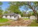 View of the exterior and backyard, featuring a lake and a small white shed at 151 Naranja Rd, Debary, FL 32713