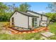 Charming home exterior with sliding glass door, wood accents, and beautiful landscaping at 151 Naranja Rd, Debary, FL 32713