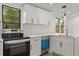 Modern kitchen featuring white cabinets, stainless steel appliances, and white countertop at 151 Naranja Rd, Debary, FL 32713