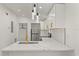 Modern kitchen with stainless steel appliances, white cabinets, and marble countertops at 151 Naranja Rd, Debary, FL 32713