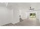 Open living room with hardwood floors, a ceiling fan, and sliding glass door to a garden at 151 Naranja Rd, Debary, FL 32713