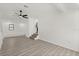 Bright living room with wood-look floors, white walls, and small stairs at 151 Naranja Rd, Debary, FL 32713