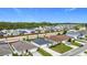 Wide aerial view of a suburban neighborhood with well-maintained homes and green spaces on a bright day at 16369 Yelloweyed Dr, Clermont, FL 34714