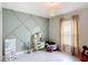 Playful bedroom with unique wall design and neutral tones at 16369 Yelloweyed Dr, Clermont, FL 34714