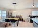 Dining area with modern lighting, stylish table set, and a view of the outdoor pool at 16369 Yelloweyed Dr, Clermont, FL 34714