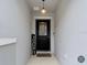 Inviting entryway featuring a black front door with glass accents and stylish decor at 16369 Yelloweyed Dr, Clermont, FL 34714
