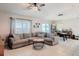 Open-concept living area with a comfortable sectional sofa, dining area, and bright windows at 16369 Yelloweyed Dr, Clermont, FL 34714