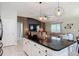 Open concept living area with a spacious island and modern pendant lighting at 16369 Yelloweyed Dr, Clermont, FL 34714