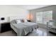 Bright bedroom with tiled floors, a large window, and simple decor at 16369 Yelloweyed Dr, Clermont, FL 34714