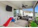 Covered patio including ceiling fan, outdoor seating, and a safe place for to play at 16369 Yelloweyed Dr, Clermont, FL 34714
