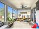 Screened patio provides bug-free entertaining with fan and furniture, adjacent to a yard at 16369 Yelloweyed Dr, Clermont, FL 34714