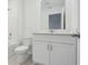 Modern bathroom with a white toilet, bathtub, and vanity at 16403 Bird Of Paradise Ave, Clermont, FL 34714