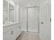 Bathroom showcasing a shower and double vanity sinks at 16403 Bird Of Paradise Ave, Clermont, FL 34714