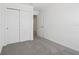 Simple bedroom featuring neutral carpet, white walls, and a closet with sliding doors at 16403 Bird Of Paradise Ave, Clermont, FL 34714