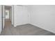 Simple bedroom featuring neutral carpet, white walls, and a closet with sliding doors at 16403 Bird Of Paradise Ave, Clermont, FL 34714