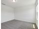 Neutral bedroom with a gray carpet, white walls, and natural lighting at 16403 Bird Of Paradise Ave, Clermont, FL 34714