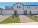 Charming townhome with a brick walkway, one-car garage, and well manicured lawn at 16403 Bird Of Paradise Ave, Clermont, FL 34714