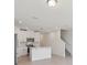 Modern kitchen with white cabinetry, stainless steel appliances, and a center island at 16403 Bird Of Paradise Ave, Clermont, FL 34714