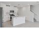 Bright kitchen features white cabinets, stainless steel appliances, tile flooring, and a center island at 16403 Bird Of Paradise Ave, Clermont, FL 34714