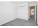 A bright bedroom with closet doors and a door leading to another room at 16443 Bird Of Paradise Ave, Clermont, FL 34714