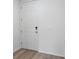 Interior view of the home's entryway, featuring a white door and wood look floor at 16443 Bird Of Paradise Ave, Clermont, FL 34714