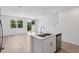 Open concept kitchen featuring white cabinets, stainless steel appliances, and a center island at 16443 Bird Of Paradise Ave, Clermont, FL 34714